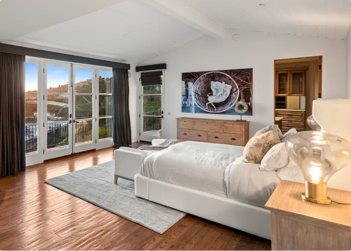 Luxury bedroom in a private residence for artist recovery with a balcony view and modern decor.