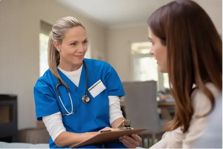 A nurse in blue scrubs providing medical detox support and safe withdrawal supervision to a patient.