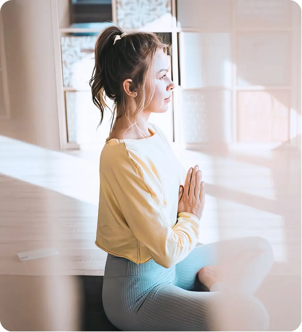 Woman practicing meditation and mindfulness therapy during addiction recovery treatment