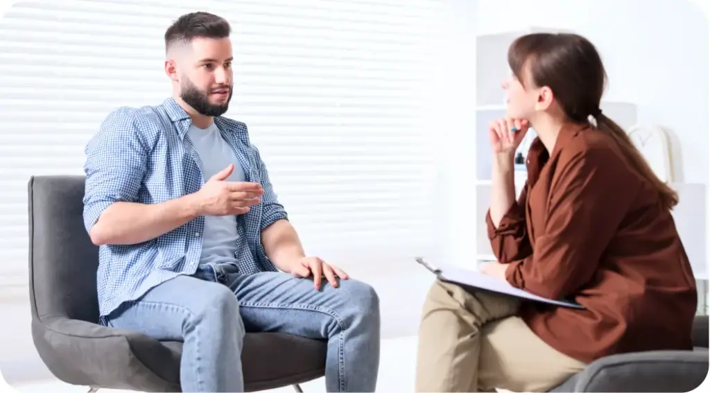 Patient speaking with a therapist during a trauma-informed addiction counseling session