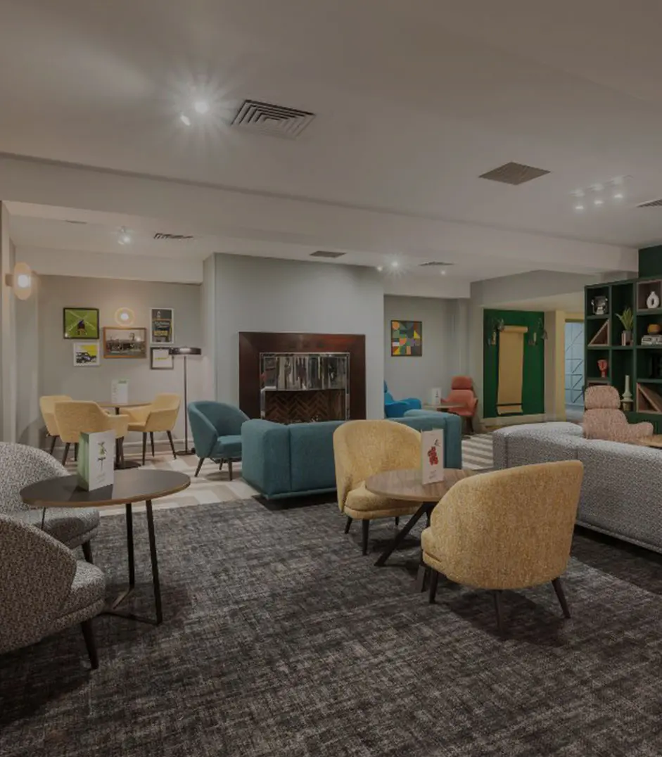 Comfortable entertainment lounge with modern seating and relaxing community space in a luxury recovery environment