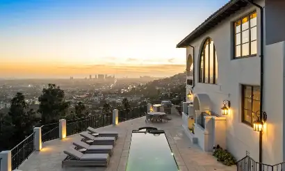 Legacy Healing Center Wattles luxury rehab residence in Los Angeles featuring a private pool, hillside setting, outdoor lounge area, and panoramic city views at sunset.