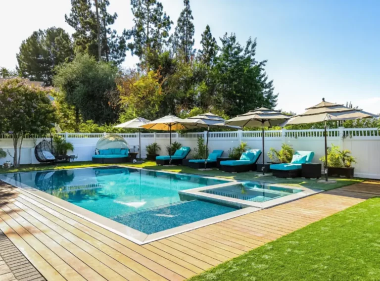 Outdoor wellness area at a Los Angeles luxury rehab residence featuring a swimming pool, lounge seating, landscaped surroundings, and relaxing residential spaces.